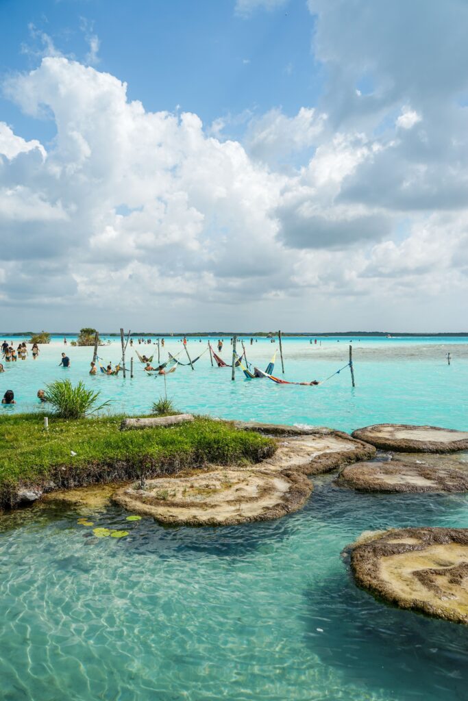 Explore the turquoise waters of Bacalar Lagoon, Mexico, with a stunning view of hammocks over the water.